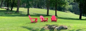 Photo of red Adirondack chairs on the Battell Stoeckle Estate, Norfolk, Connecticut.