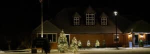Photo of holiday-decorated trees in front of town hall, Norfolk, Connecticut.