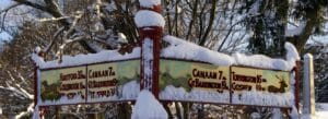 Winter photo of the historic mile sign on the corner of the village green, Norfolk, Connecticut.