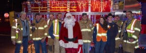 Santa, flanked by fellow volunteer firemen, in Norfolk, Conn.