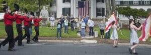Photo of people on the steps of Whitehouse, watching the Norfolk, Connecticut, Memorial Day parade go by.