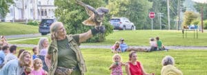 Photo of a woman showing a hawk at Friday Nights on the Green, Norfolk, Connecticut.