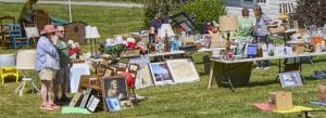 Photo of the Lions Club tag sale, with people looking at the items on the tables, Norfolk, Connecticut.