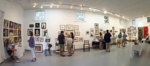 Photo of people looking at artwork during an exhibition, Norfolk, Connecticut.