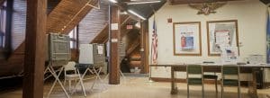 Photo of the second floor of town hall, Norfolk, Connecticut, showing voting machines during elections.