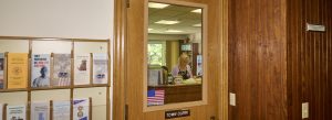 Photo of the Norfolk town clerk's office taken through the window in the office door.