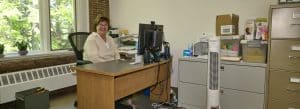 Photo of Norfolk's social services administrator at her desk in Town Hall.