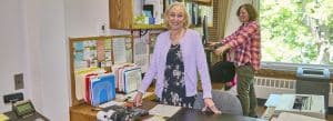 Photo of Norfolk's town clerk behind the counter in her office in Town Hall.